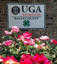 UGA Extension Baker County sign on a building beside flower bed